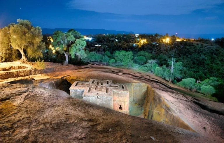 bet giyorgis rock hewn church in the night with the moon in lalibela ethiopia