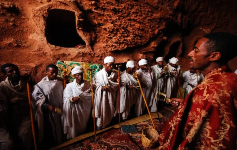 lalibela ethiopia group of priests chanting prayers inside rock hewn